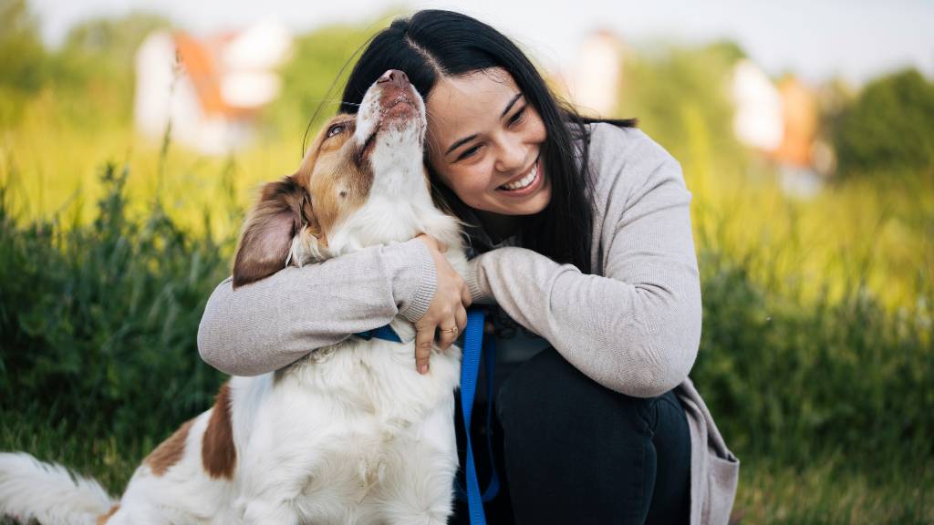 woman cuddling emotional support dog
